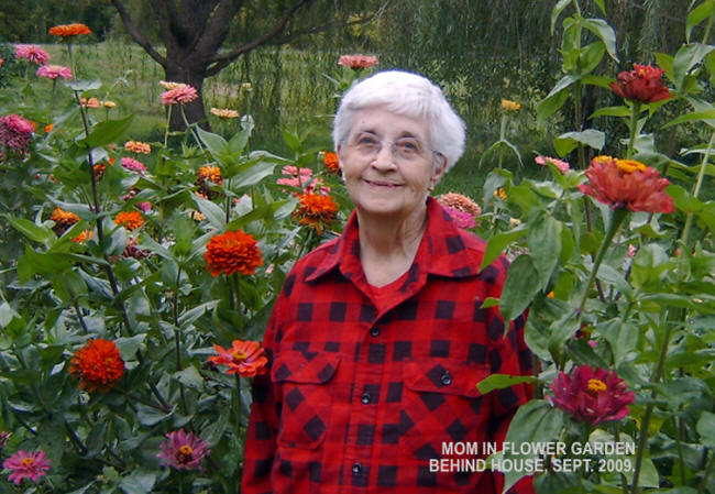 Mom in the flower garden behind the house.