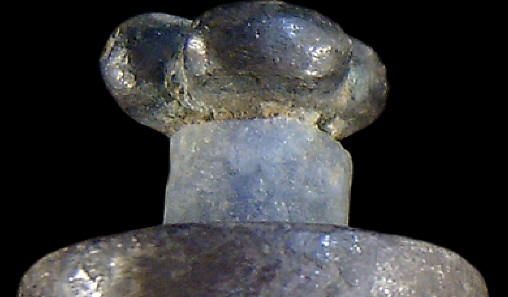 Quartz crystal ring on Moche culture silver labret, Peru.