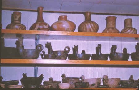 Harry McPherson collection----shelves of Mississippian pots.