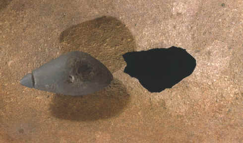 Close up view of a hole worn througn the grinding cavity.
