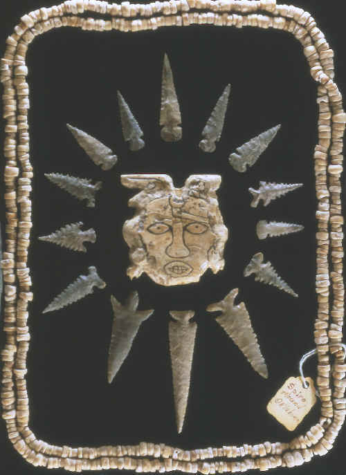 Arrow points, shell beads and carved shell maskett from Craig Mound.