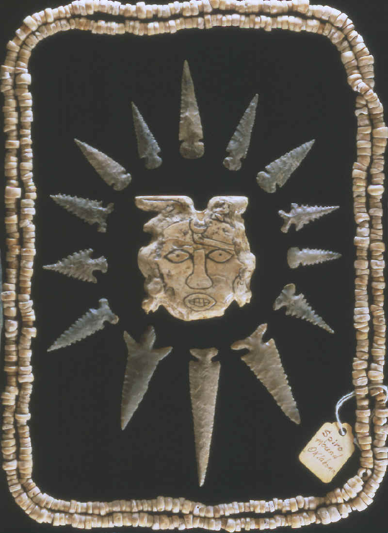 Arrow points, shell beads and carved shell maskett from Spiro.