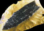 Largest Clovis point laying on large Clovis biface.